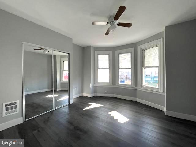 2437 West Toronto Street Philadelphia, PA 19132 - Photo 10 of 14 a view of empty room with wooden floor and fan