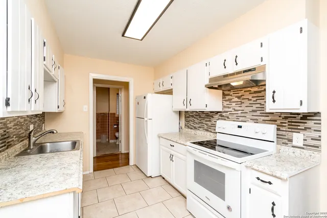 a kitchen with a stove and a sink