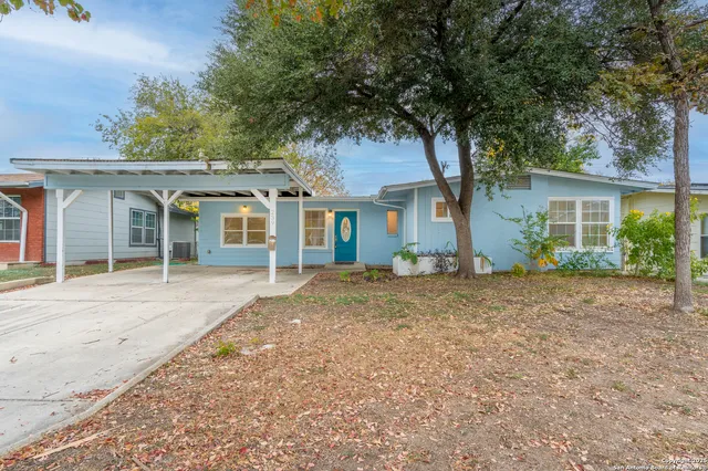 front view of a house with a tree
