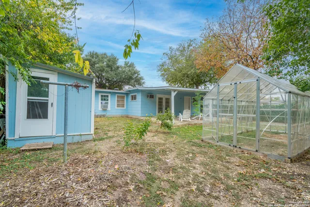 a view of house with backyard space and garden