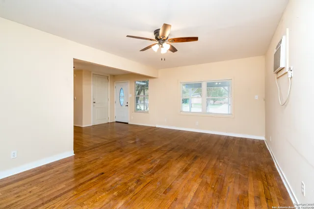 wooden floor in an empty room with a window