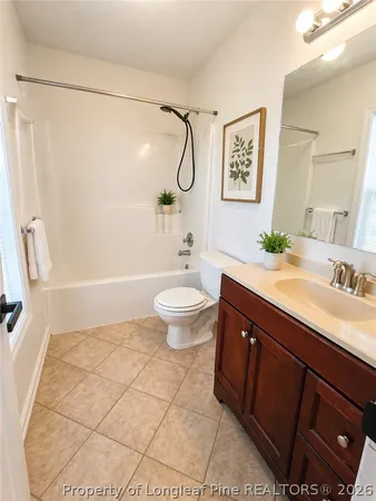 a bathroom with a granite countertop sink a toilet a mirror and shower