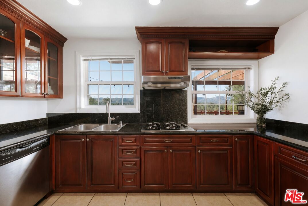 5741 Rolling Road Woodland Hills, CA 91367 - Photo 13 of 37 a kitchen with granite countertop a sink and a stove