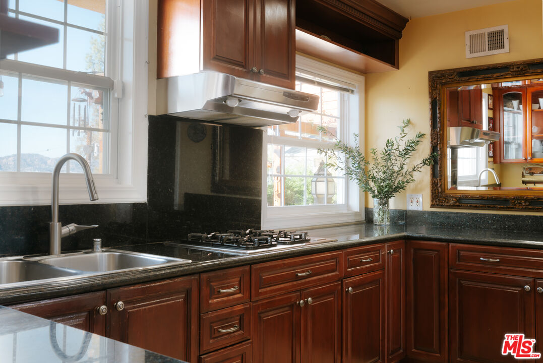 5741 Rolling Road Woodland Hills, CA 91367 - Photo 15 of 37 a kitchen with granite countertop a sink and a window
