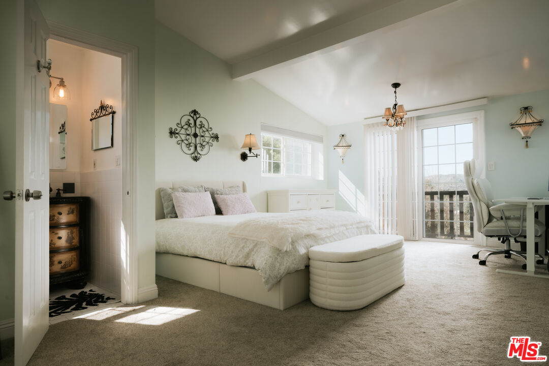 5741 Rolling Road Woodland Hills, CA 91367 - Photo 21 of 37 a spacious bedroom with a bed and a table in it