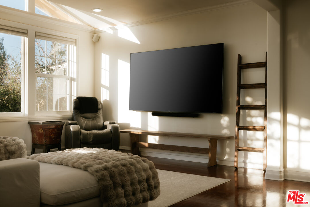 5741 Rolling Road Woodland Hills, CA 91367 - Photo 9 of 37 a living room with a bed furniture and a flat screen tv