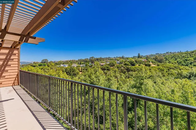a view of a balcony with wooden fence