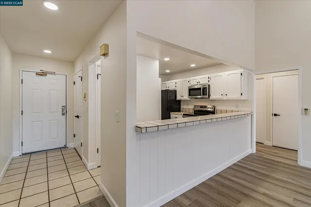 a view of a kitchen with wooden floor and a sink
