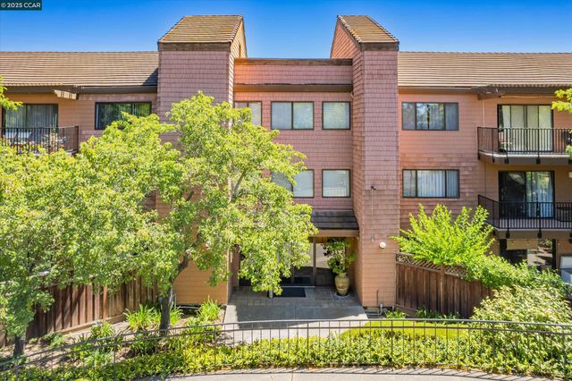 a flower garden is sitting in front of house