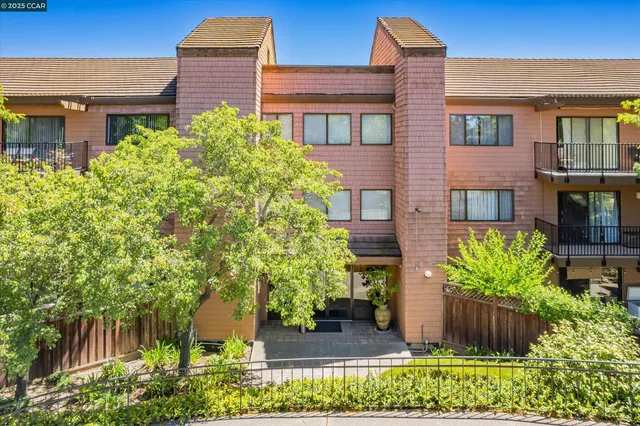 a flower garden is sitting in front of house