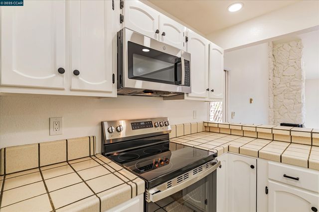 a bedroom with two beds and a large window