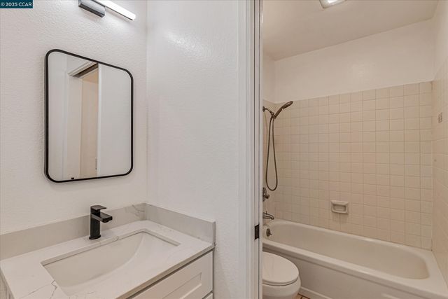 a bathroom with a sink toilet a mirror and shower