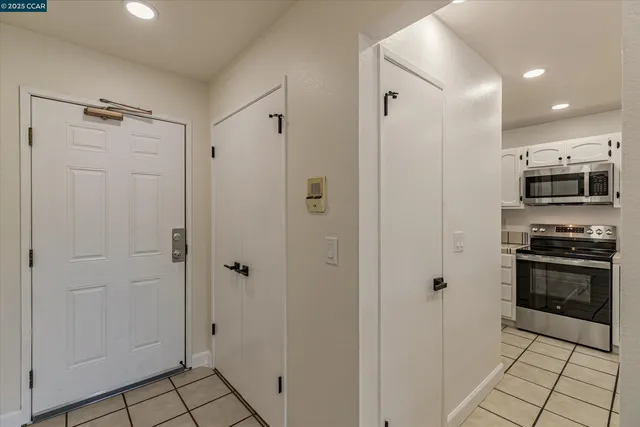 a view of a kitchen with a refrigerator and a stove top oven