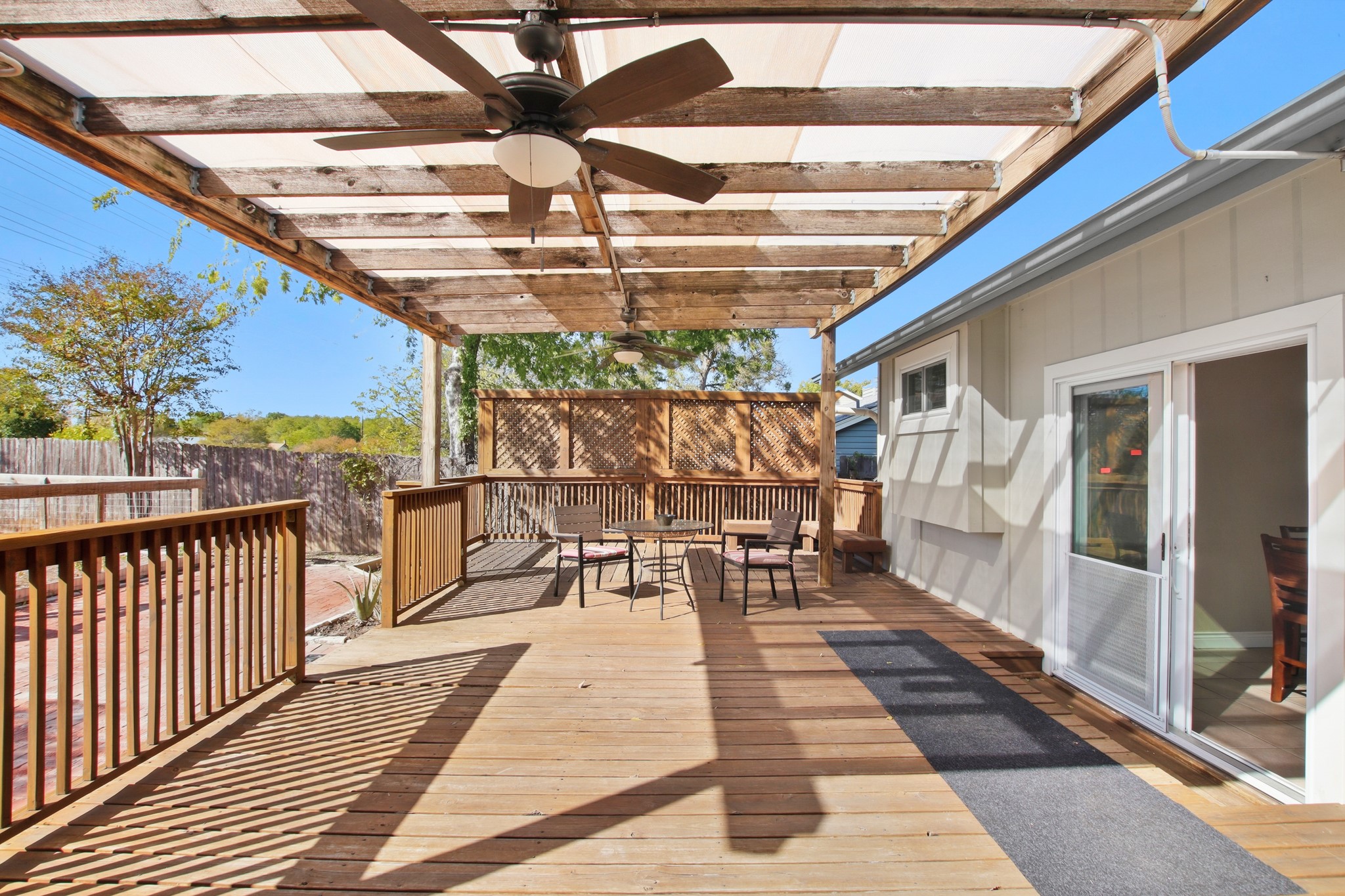 1711 Prairie Hen Cove Austin, TX 78758 - Photo 15 of 18 Wooden deck with ceiling fan and a fenced backyard