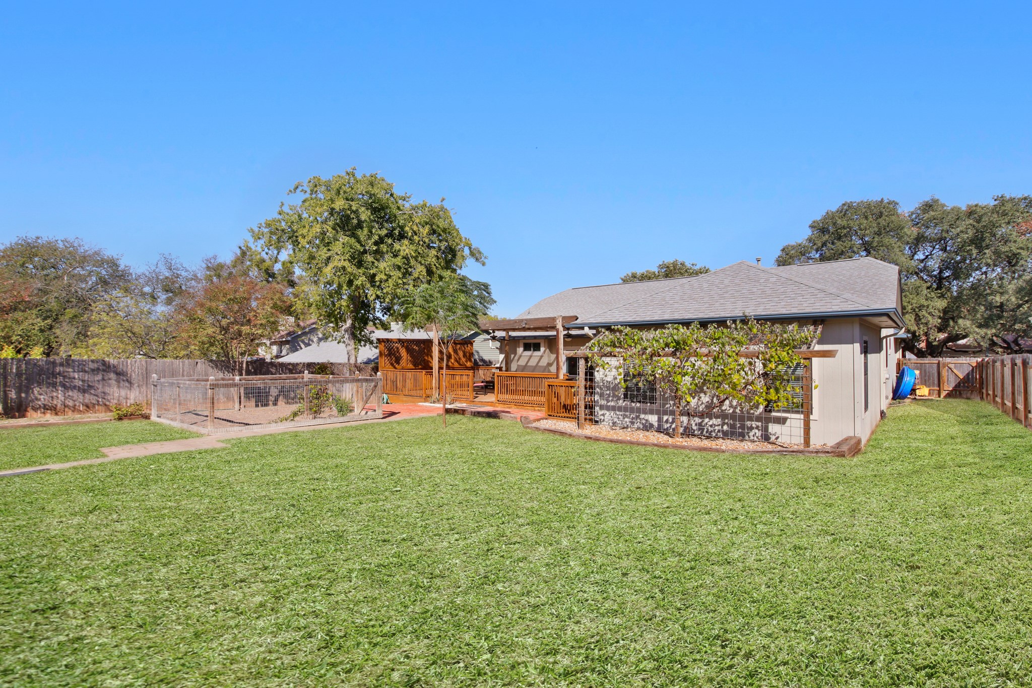 1711 Prairie Hen Cove Austin, TX 78758 - Photo 17 of 18 Fenced backyard with a deck