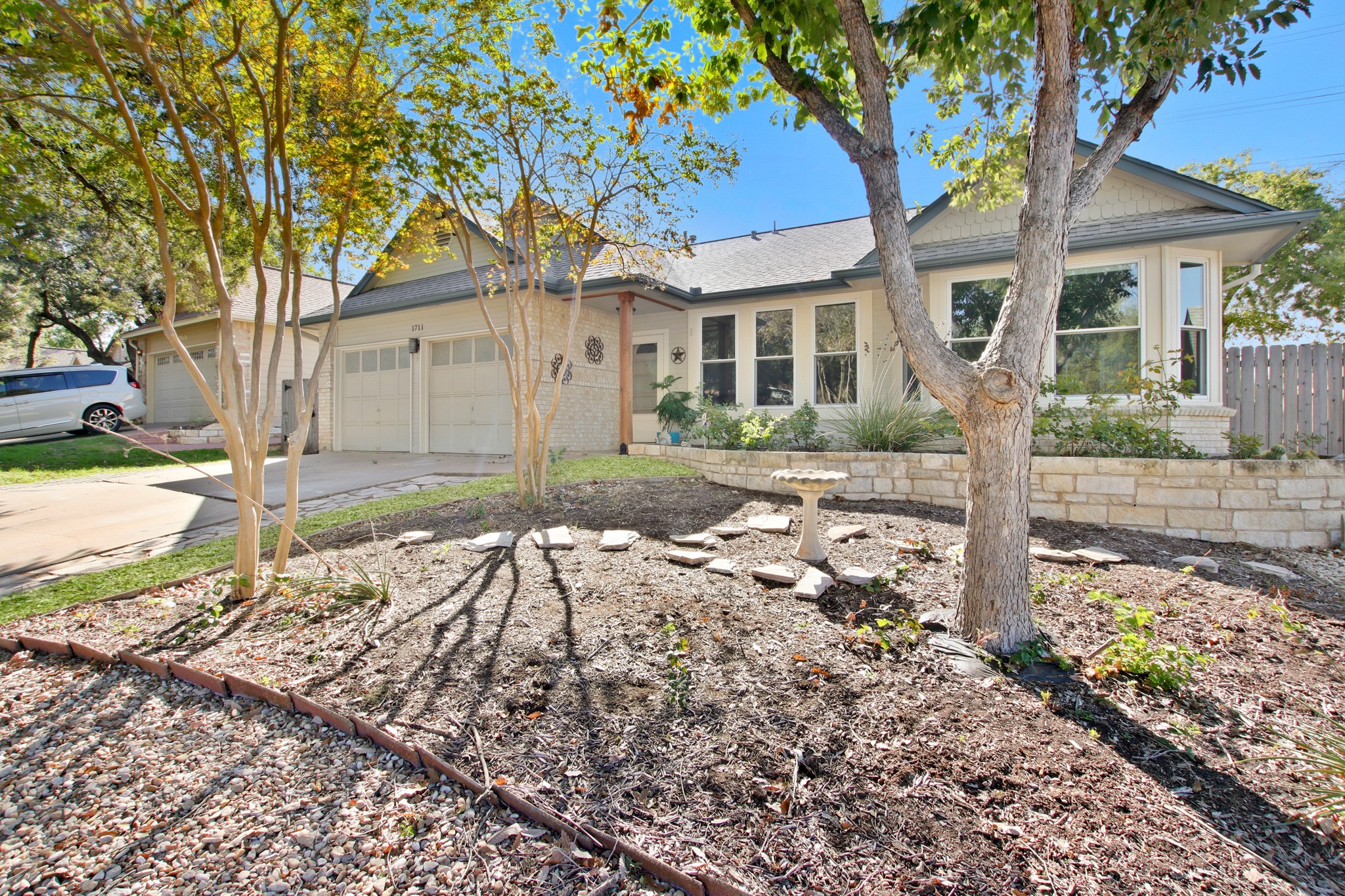 1711 Prairie Hen Cove Austin, TX 78758 - Photo 2 of 18 Single story home featuring concrete driveway, brick siding, a garage, and roof with shingles