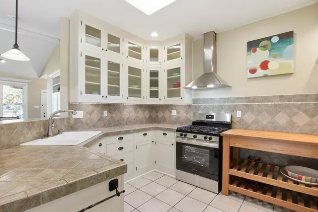 a kitchen with granite countertop a stove and a sink