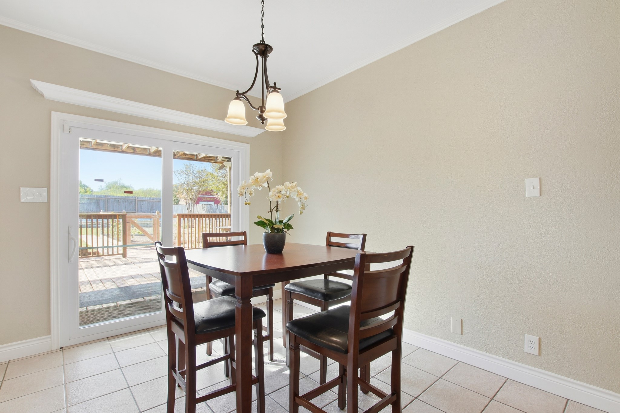 1711 Prairie Hen Cove Austin, TX 78758 - Photo 5 of 18 Dining area featuring light tile patterned floors and a chandelier