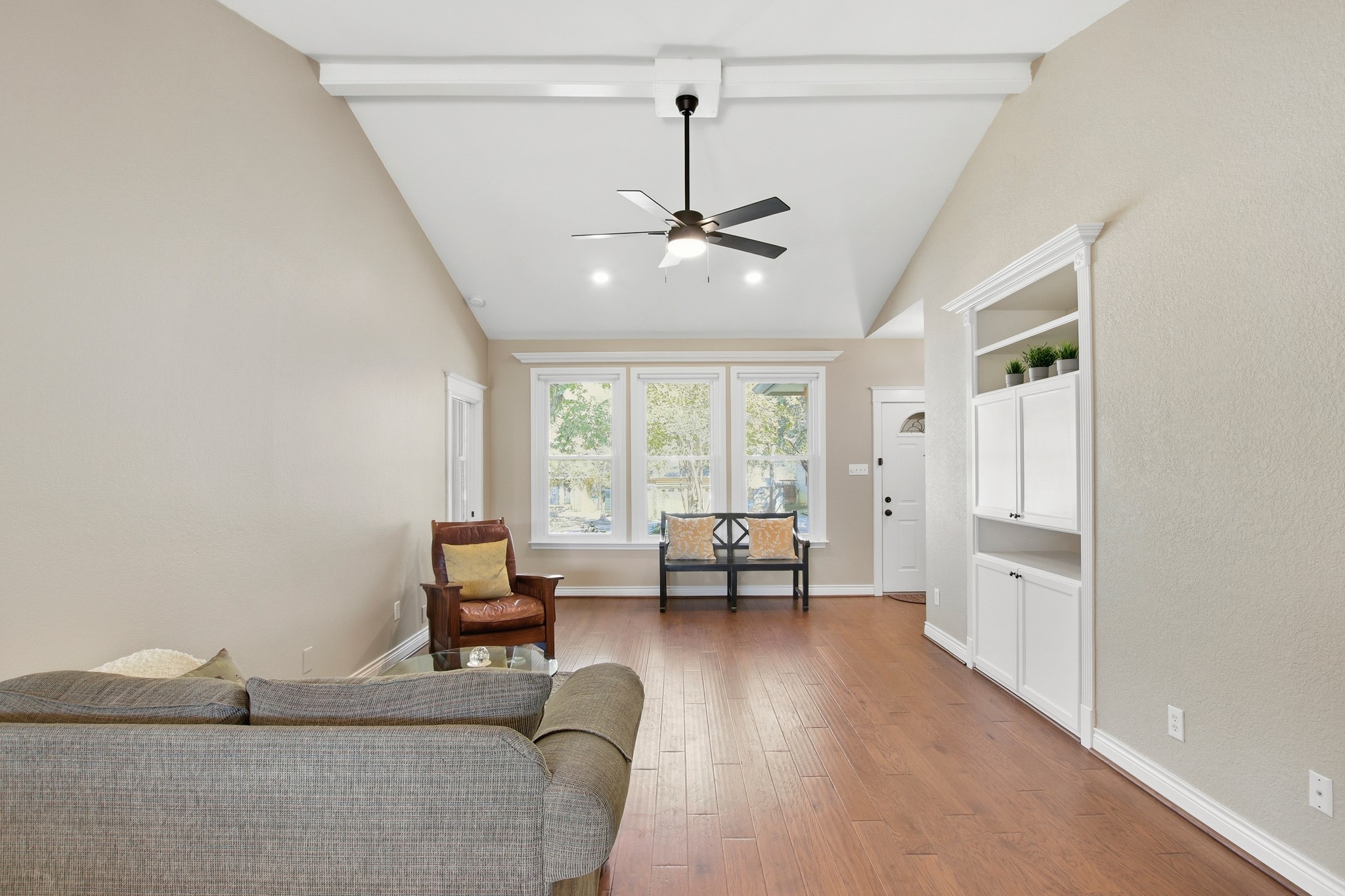 1711 Prairie Hen Cove Austin, TX 78758 - Photo 7 of 18 Sitting room with beam ceiling, high vaulted ceiling, light wood finished floors, and a ceiling fan