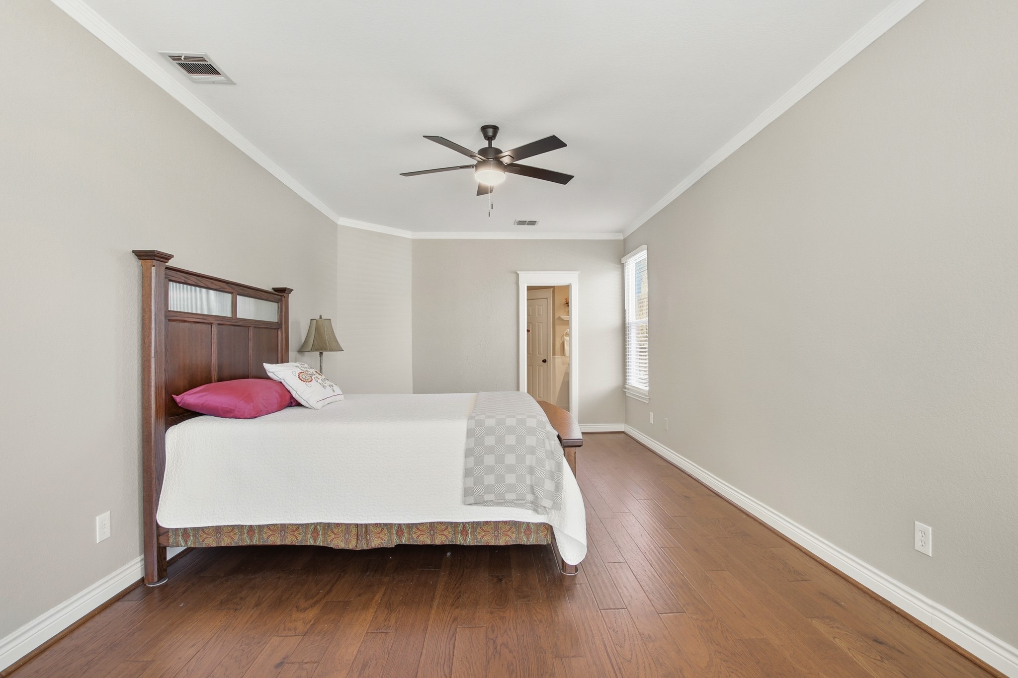1711 Prairie Hen Cove Austin, TX 78758 - Photo 9 of 18 Bedroom with ornamental molding, wood finished floors, and a ceiling fan