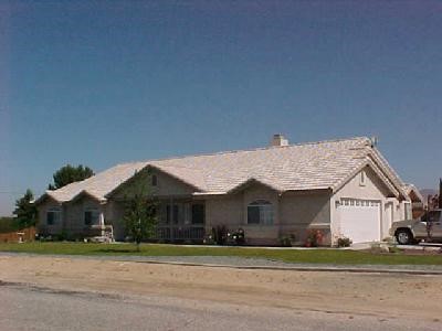 18580 Chapea Road Apple Valley, CA 92307 - Photo 1 of 1 a front view of a house with a yard and garage