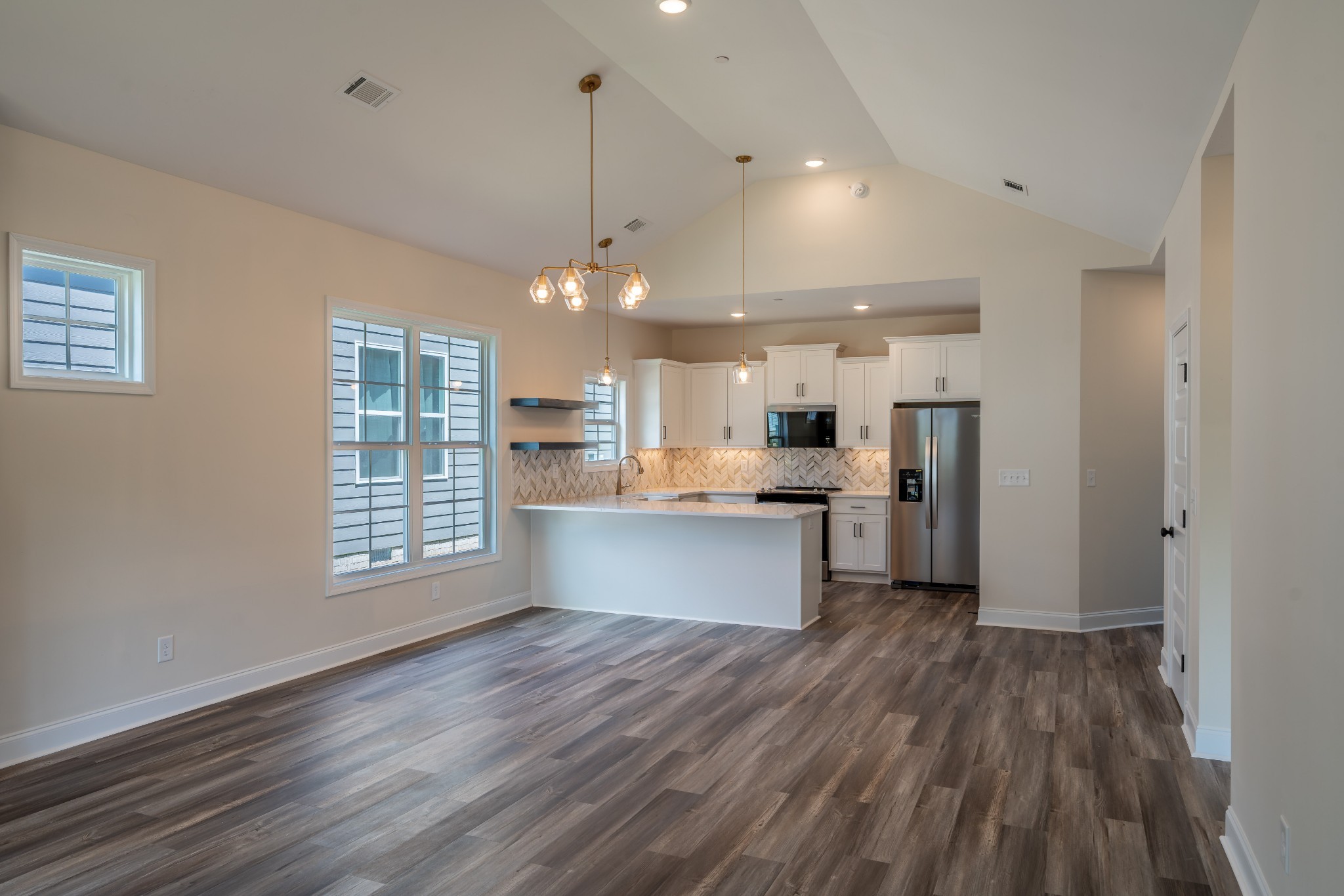 579 Centre Street Pleasant View, TN 37146 - Photo 8 of 36 a large kitchen with stainless steel appliances a large counter top a sink a refrigerator and a window