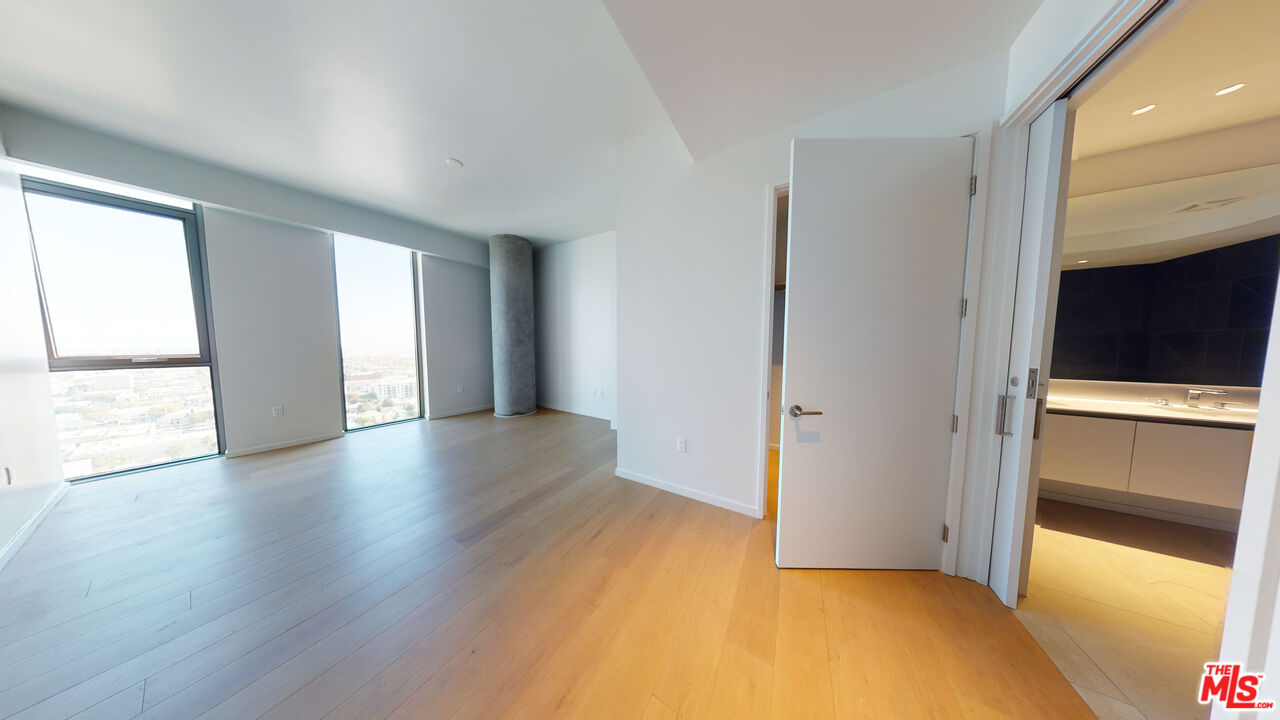 2801 Sunset Place, Unit PH15 Los Angeles, CA 90005 - Photo 11 of 23 a view of an empty room with wooden floor and a window