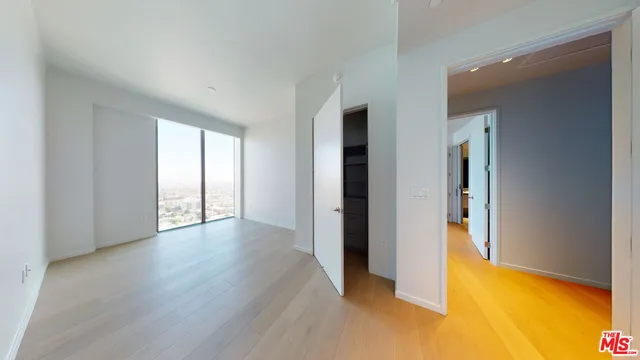 a bathroom with a toilet a sink and a large mirror
