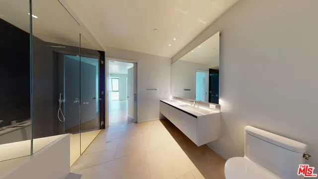 a large kitchen with a large counter top a sink a stove and a refrigerator