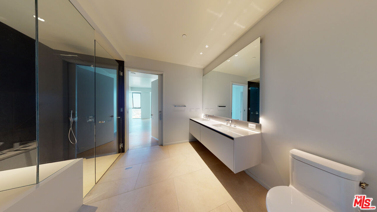 2801 Sunset Place, Unit PH15 Los Angeles, CA 90005 - Photo 13 of 23 a bathroom with a sink mirror vanity and toilet