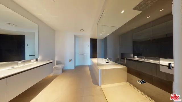 a bathroom with a shower and a glass door