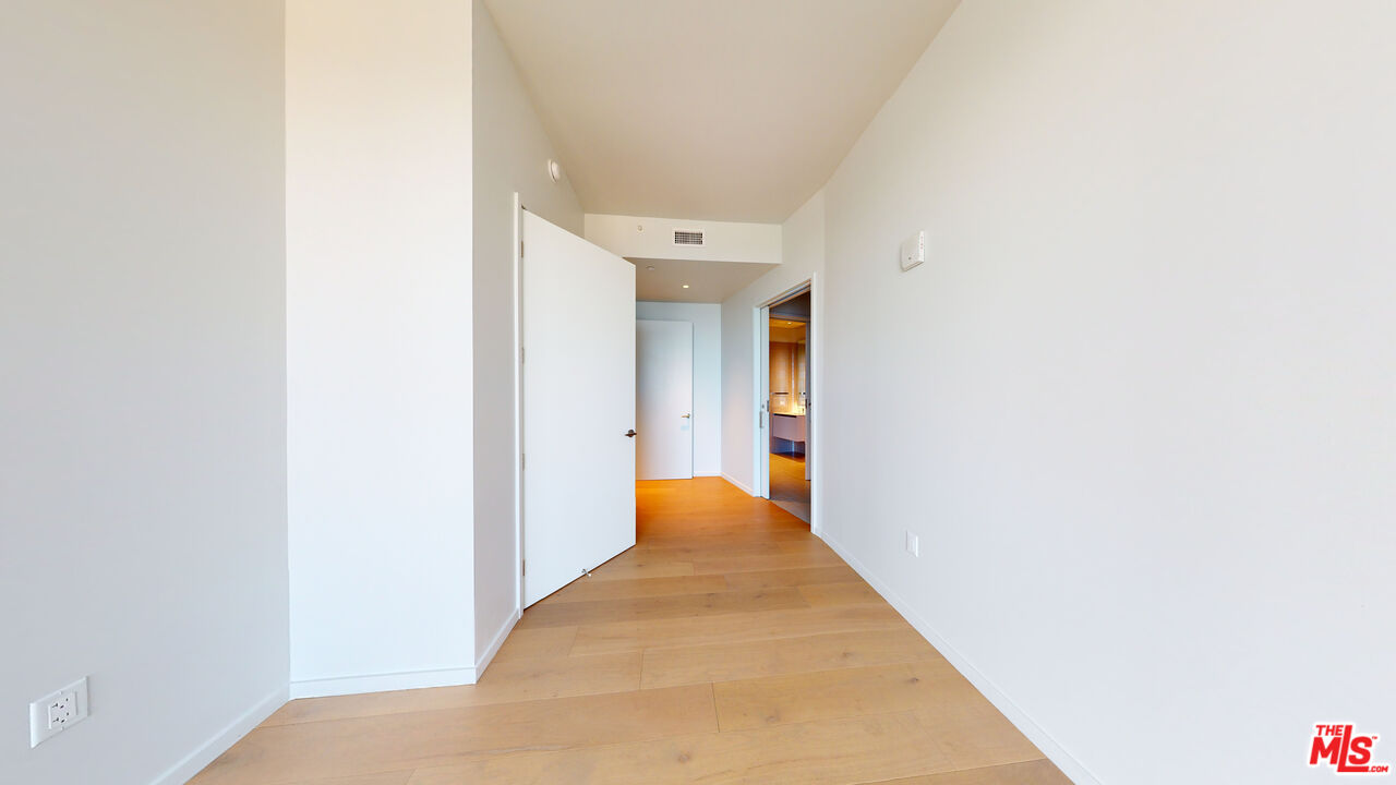 2801 Sunset Place, Unit PH15 Los Angeles, CA 90005 - Photo 17 of 23 a view of a hallway with wooden floor