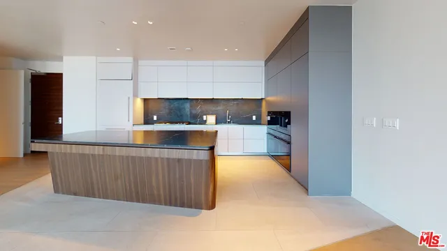 a kitchen with stainless steel appliances a refrigerator and a sink