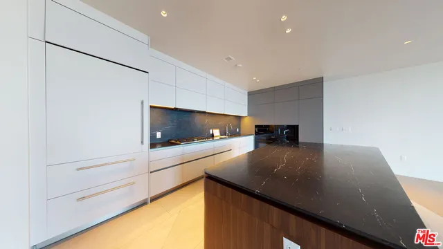 a kitchen with stainless steel appliances a stove and a microwave