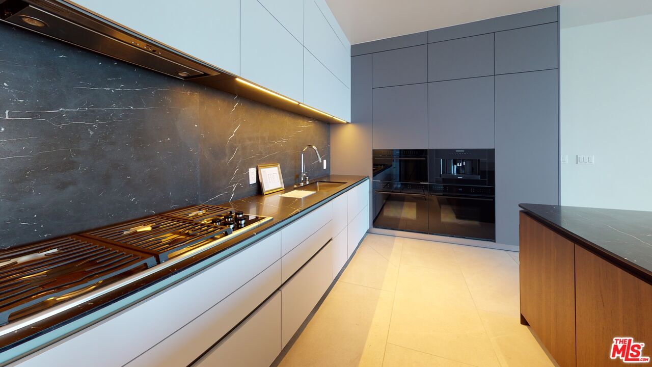 2801 Sunset Place, Unit PH15 Los Angeles, CA 90005 - Photo 4 of 23 a kitchen with stainless steel appliances a stove and a microwave
