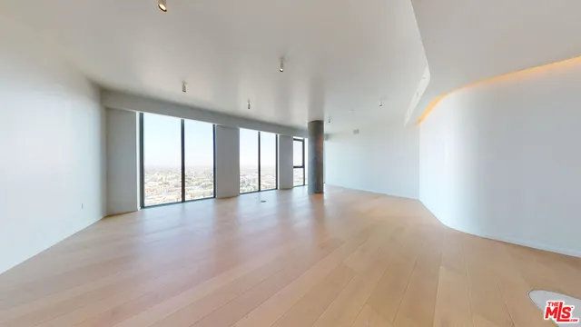 a view of a hallway with wooden floor and kitchen