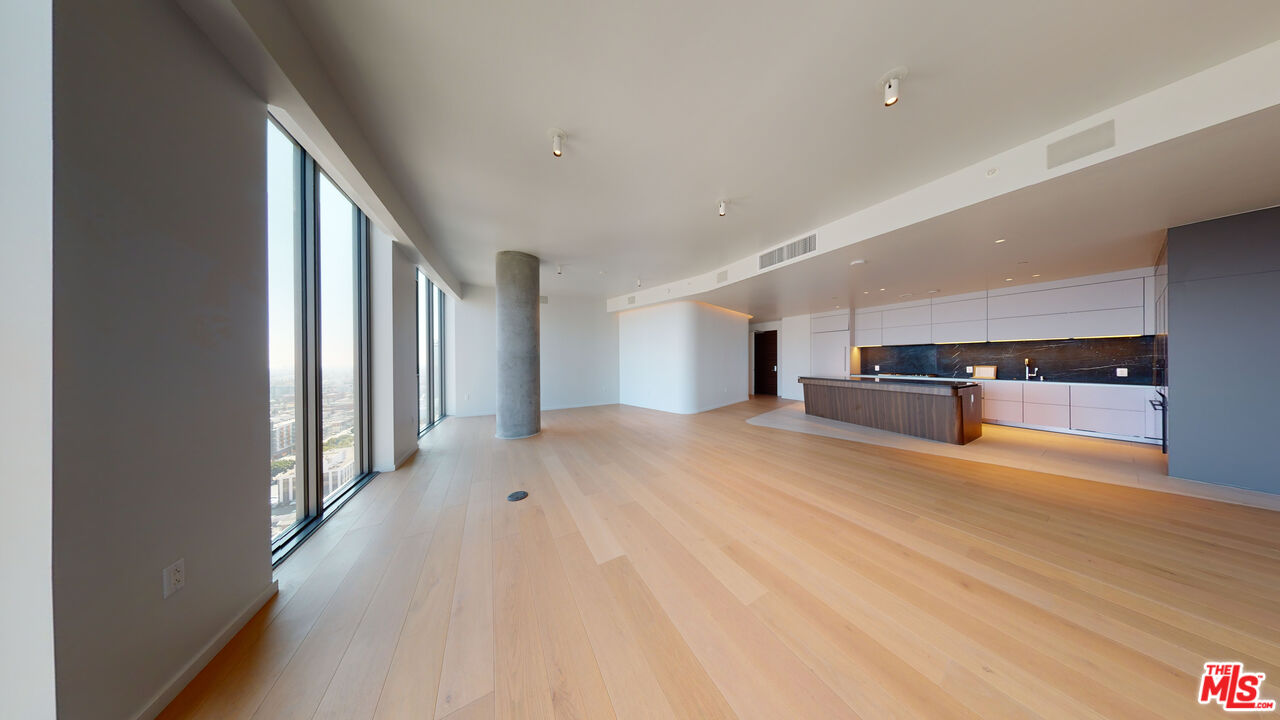 2801 Sunset Place, Unit PH15 Los Angeles, CA 90005 - Photo 6 of 23 a view of a hallway with wooden floor and kitchen