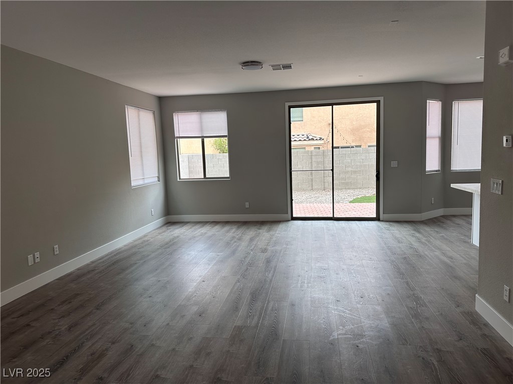 8993 Dorrell Lane Las Vegas, NV 89149 - Photo 4 of 15 Spare room with dark wood-type flooring and baseboards