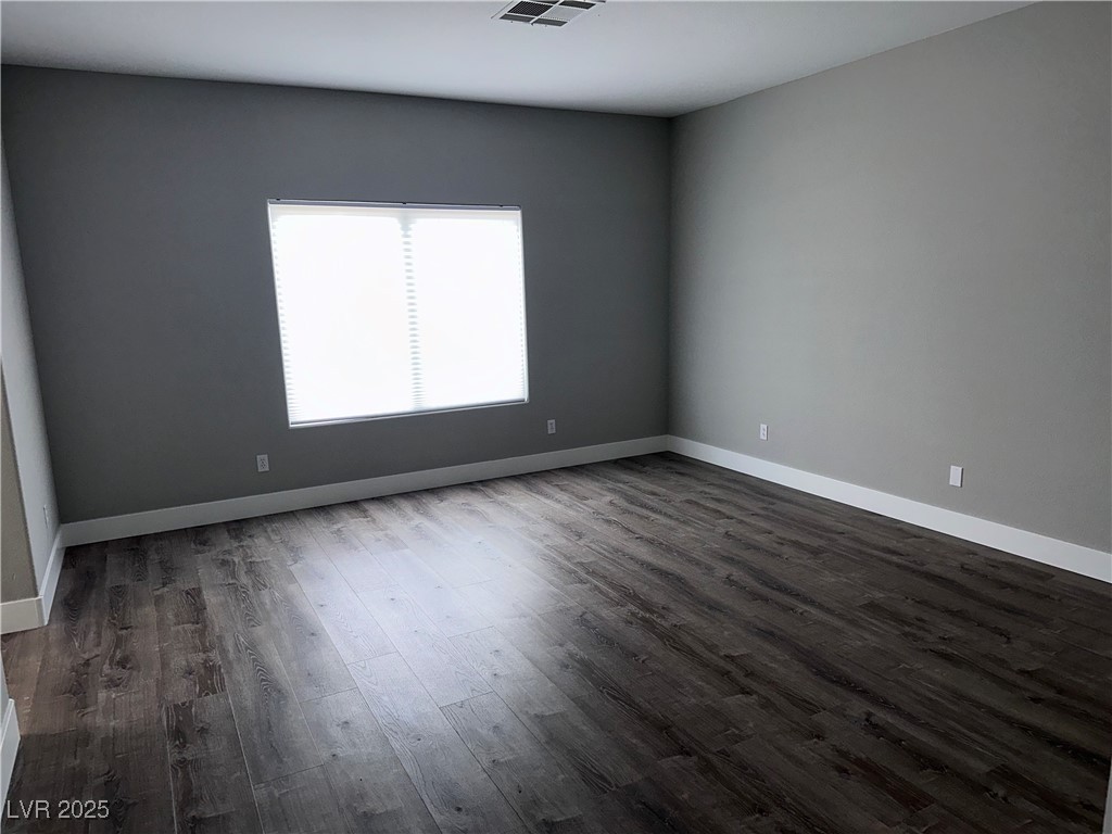 8993 Dorrell Lane Las Vegas, NV 89149 - Photo 7 of 15 Spare room with dark wood-style flooring
