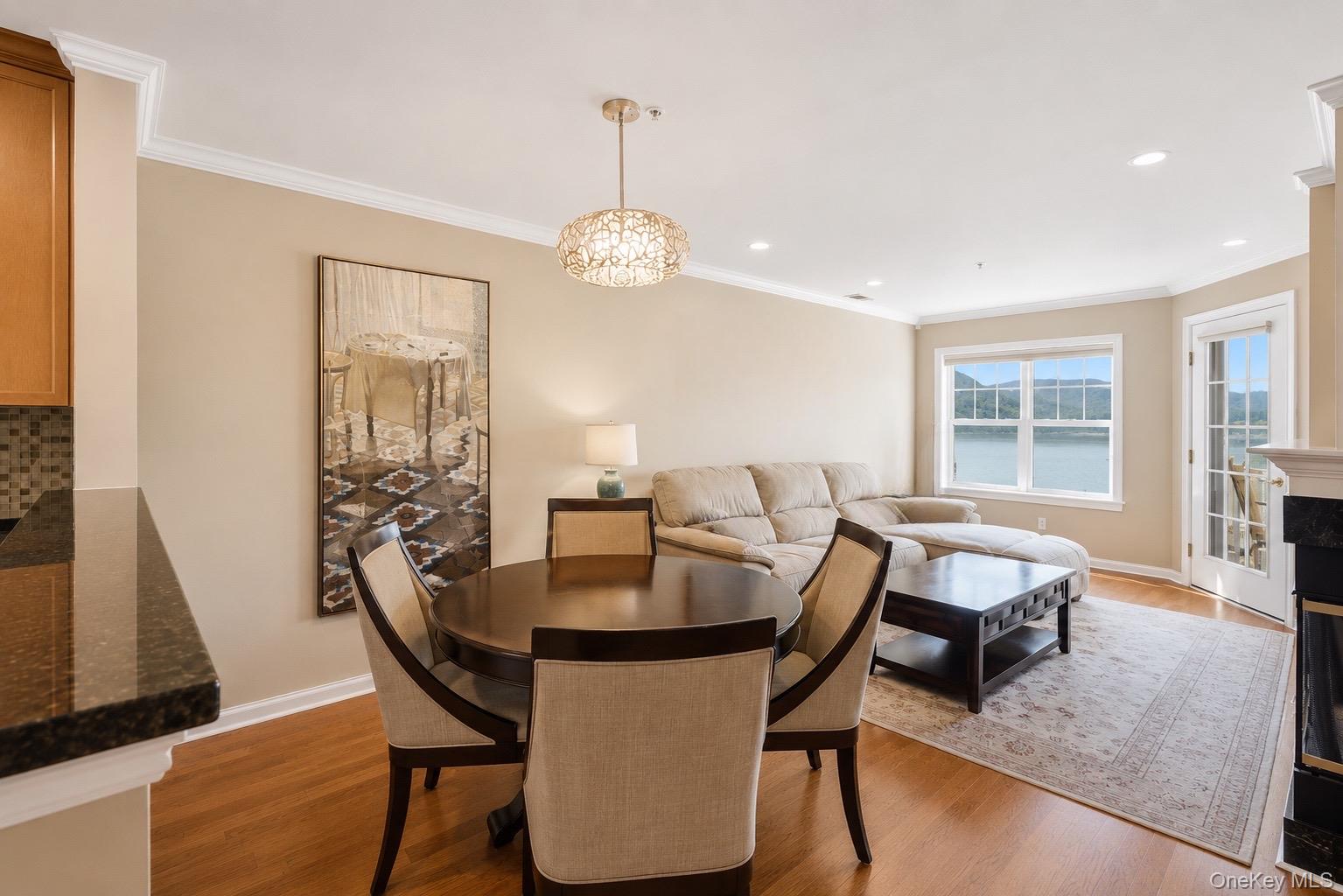 323 Waterside Close Peekskill, NY 10566 - Photo 6 of 42 Open-concept living area with beautiful crown molding and unobstructed views of the Hudson River and Bear Mountain