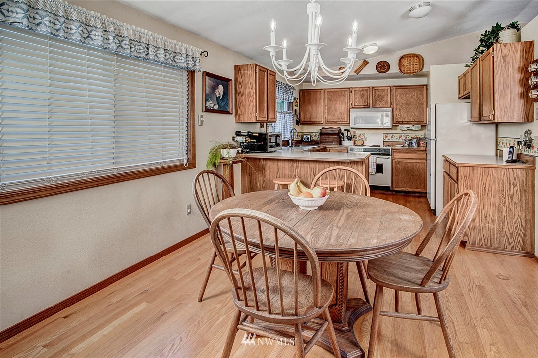 23431 12th Place West Bothell, WA 98021 - Photo 11 of 26 a dining room with furniture and wooden floor