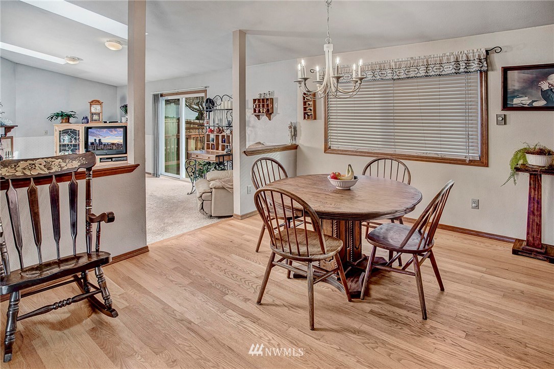 23431 12th Place West Bothell, WA 98021 - Photo 12 of 26 a dining room with furniture wooden floor and a chandelier