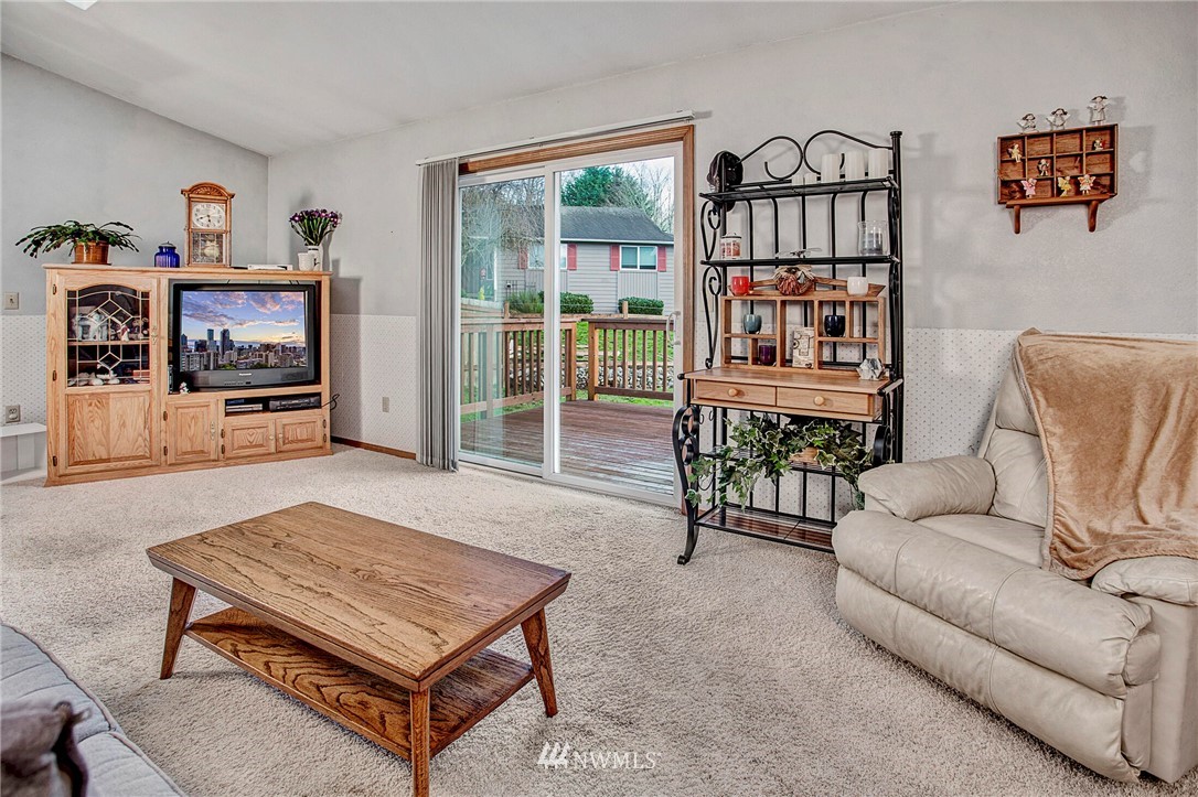 23431 12th Place West Bothell, WA 98021 - Photo 14 of 26 a living room with furniture a flat screen tv and a table