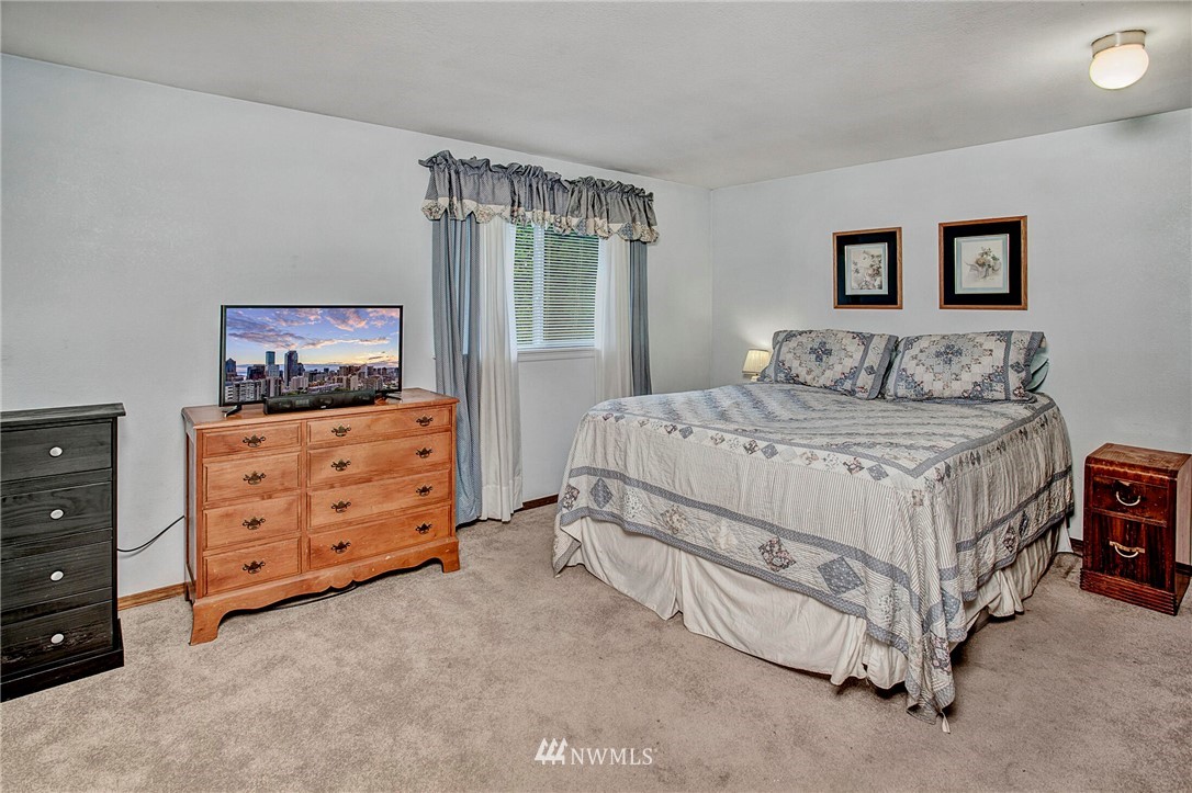 23431 12th Place West Bothell, WA 98021 - Photo 15 of 26 a bedroom with a bed a couch and dresser