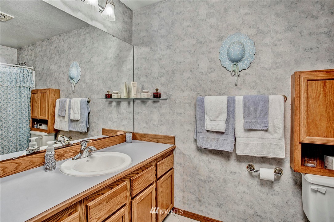 23431 12th Place West Bothell, WA 98021 - Photo 17 of 26 a bathroom with a sink and a mirror