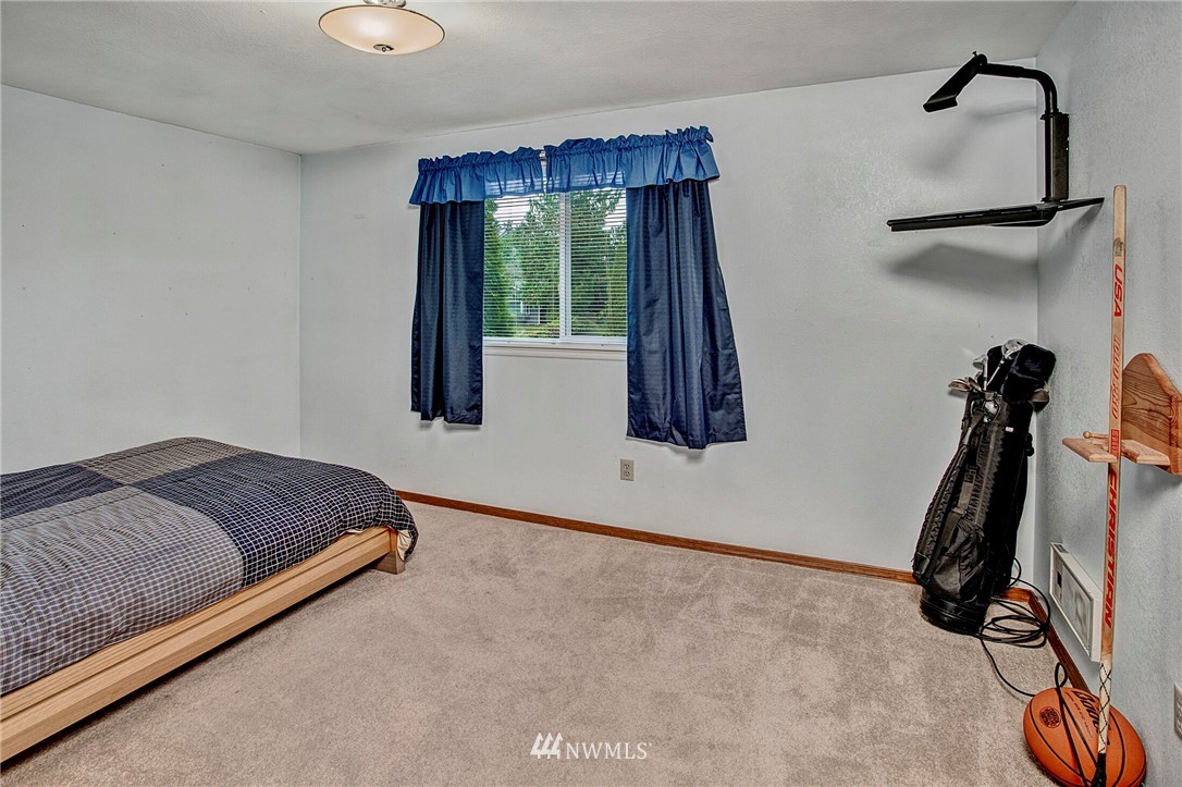 23431 12th Place West Bothell, WA 98021 - Photo 19 of 26 a room with a bed and a window