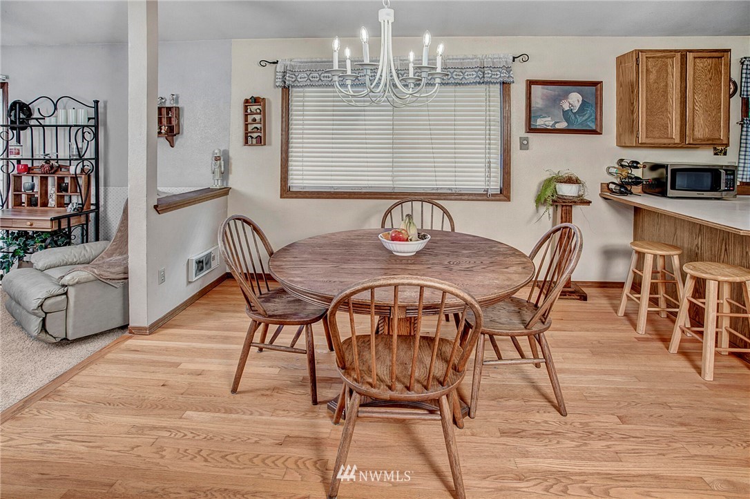 23431 12th Place West Bothell, WA 98021 - Photo 10 of 26 a view of a dining room with furniture and wooden floor