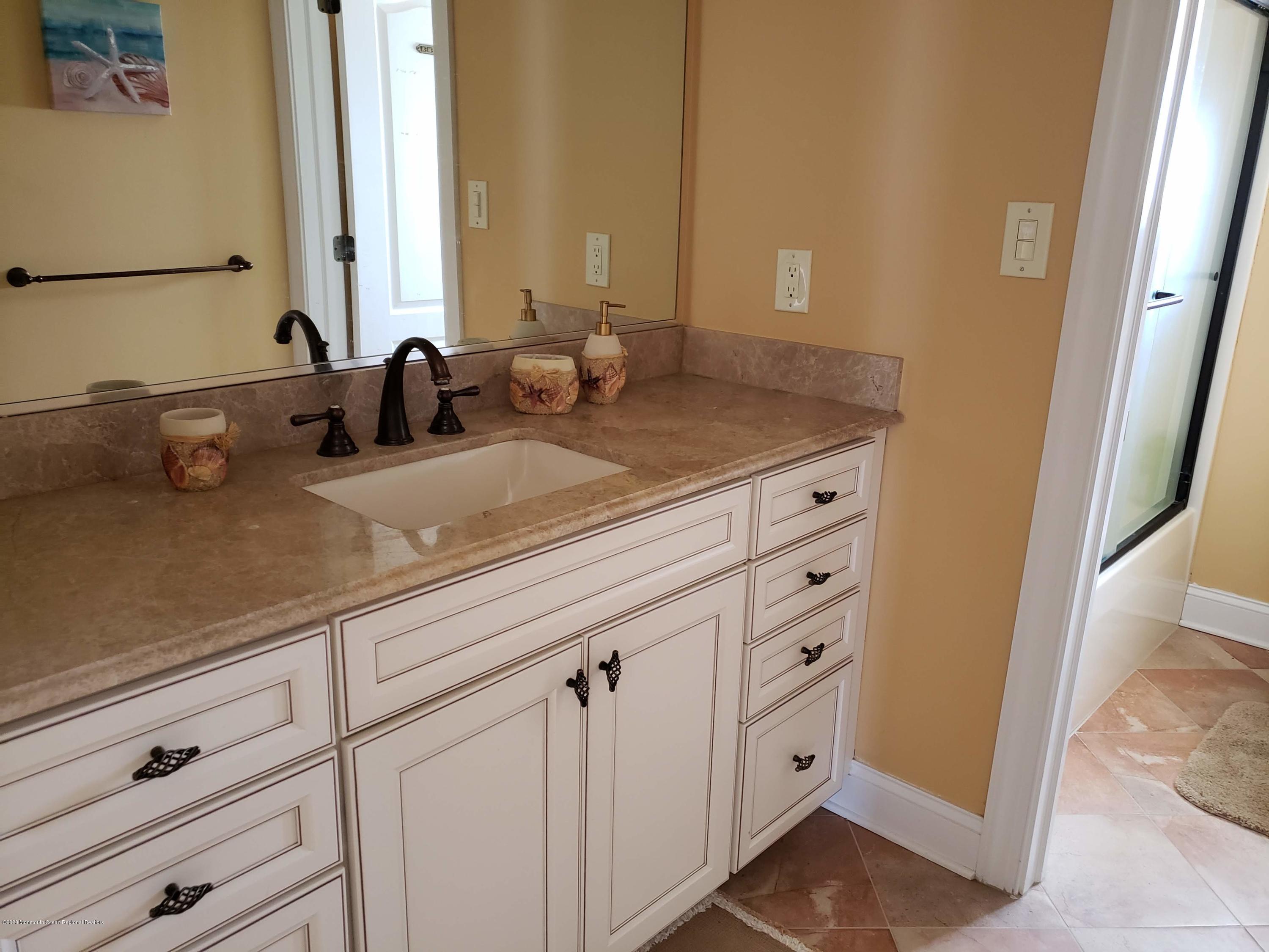 214 Heron Road Tuckerton, NJ 08087 - Photo 12 of 31 a bathroom with a double vanity sink and a mirror