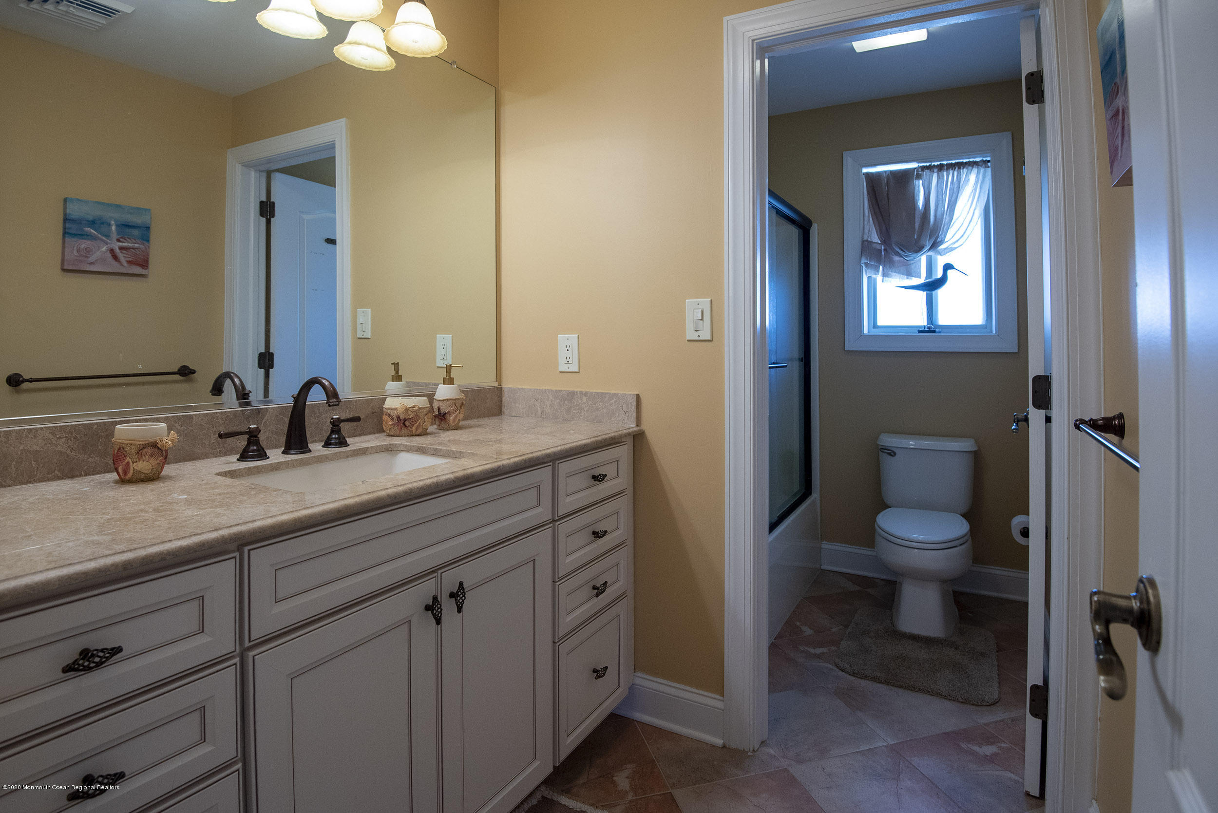 214 Heron Road Tuckerton, NJ 08087 - Photo 16 of 31 a bathroom with a granite countertop toilet sink and mirror