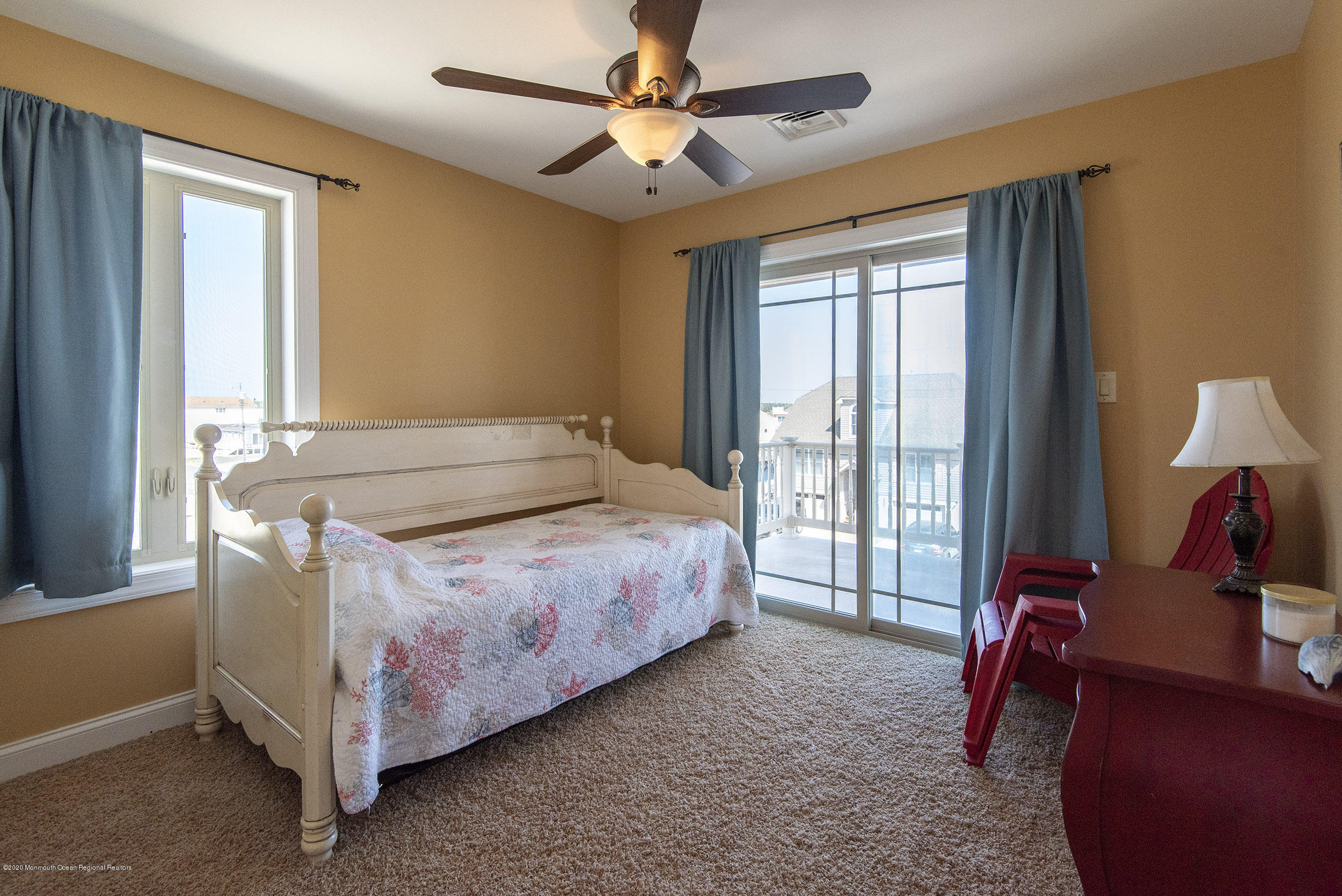 214 Heron Road Tuckerton, NJ 08087 - Photo 19 of 31 a spacious bedroom with a bed and a chandelier
